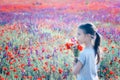 Beautiul girl holding big bouquet with poppies