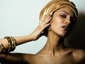 Beauty african woman in shawl on head, very elegant look with gold jewelry