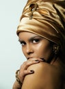 Beauty african woman in shawl on head, very elegant look with gold jewelry