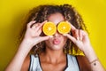 Beauty afro american Model Girl takes Juicy Oranges Royalty Free Stock Photo