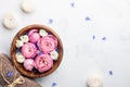 Beauty, aromatherapy and spa background with perfumed water with flowers in wooden bowl, towel and candles on stone table.Top view Royalty Free Stock Photo