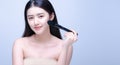 Beauty Asian Girl with Makeup Brushes. She smiling and looking to camera with powder brush, Natural makeup with beautiful v-shape Royalty Free Stock Photo