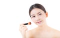 Beauty asian woman applying make up with brush isolated