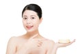 Beauty asian woman pointing display facial product on face Royalty Free Stock Photo