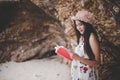 Beauty Asian woman reading book at beach. Lifestyles and Nature concept. Relaxation and leisure concept. Summer and tropical theme