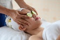 Beauty Asian woman relax and lying on massage bed with fresh cucumber mask on eyes in spa salon Royalty Free Stock Photo