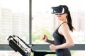 Beauty asian woman running treadmill by VR headset glasses