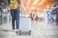 Beauty Asian woman traveling and holding suitcase in the airport. People and Lifestyles concept. Travel around the world theme. Royalty Free Stock Photo