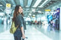 Beauty Asian woman traveling and holding suitcase in the airport. People and Lifestyles concept. Travel around the world theme. Royalty Free Stock Photo