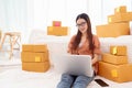 Beauty Asian woman using laptop for customer support in bedroom. Business and Technology concept. Delivery and Online shopping Royalty Free Stock Photo