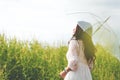 Beauty Asian woman in white dress holding transparent umbrella a Royalty Free Stock Photo