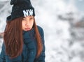 Beauty woman with winter fashion clothing with beautiful skin face in snow skii resort, closed up portrait