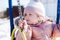 Beauty baby . Adorable girl having fun on a swing on beautiful autumn day . Portrait of cute girl playing in