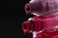 Beauty background saver nail polish is poured out of cans of vials of purple red burgundy pink close-up view from the side Royalty Free Stock Photo