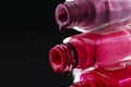 Beauty background saver nail polish is poured out of cans of vials of purple red burgundy pink close-up view from the side Royalty Free Stock Photo