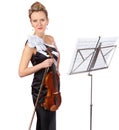 Beauty and baroque. A gorgeous violinist standing in front of a sheet music stand - portrait. Royalty Free Stock Photo