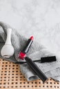 Eye mascara, red lipstick, and white nail polish on a bath towel Royalty Free Stock Photo
