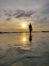 the beauty of the beach in the evening with views of the sunset and the sound of the waves washing the sand Royalty Free Stock Photo