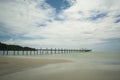 The beauty of the beach, the old wooden bridge and the sea. Royalty Free Stock Photo