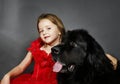 Beauty and the Beast. Girl with big black water-dog. Royalty Free Stock Photo