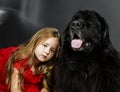 Beauty and the Beast. Girl with big black water-dog. Royalty Free Stock Photo