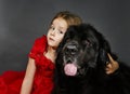 Beauty and the Beast. Girl with big black water-dog. Royalty Free Stock Photo