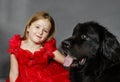 Beauty and the Beast. Girl with big black water-dog. Royalty Free Stock Photo