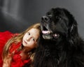 Beauty and the Beast. Girl with big black water-dog. Royalty Free Stock Photo