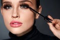 Beauty. Beautiful Woman Applying Black Mascara On Eyelashes Royalty Free Stock Photo