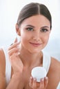 Beauty. Beautiful Woman Applying Face Cream On Soft Facial Skin Royalty Free Stock Photo