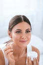 Beauty. Beautiful Woman Applying Face Cream On Soft Facial Skin Royalty Free Stock Photo