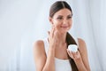 Beauty. Beautiful Woman Applying Face Cream On Soft Facial Skin Royalty Free Stock Photo