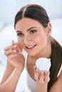 Beauty. Beautiful Woman Applying Face Cream On Soft Facial Skin Royalty Free Stock Photo