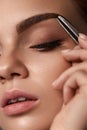 Beauty. Beautiful Woman Shaping Eyebrows With Tweezers Royalty Free Stock Photo
