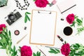 Beauty blog concept. Blogger or freelancer workspace with clipboard, notebook, retro camera, peonies and coffee mug on white backg