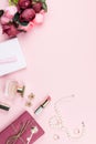 Beauty blog concept flat lay. Fashion accessories, flowers, cosmetics, jewelry on pink background, copyspace. Royalty Free Stock Photo