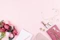 Beauty blog concept flat lay. Fashion accessories, flowers, cosmetics, jewelry on pink background, copyspace. Royalty Free Stock Photo