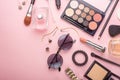 Beauty blog fashion concept. Female style of accessories: cosmetics, glasses, perfumes, eye shadows, tush on a pink background. Royalty Free Stock Photo