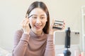 Beauty blogger, asian young woman, girl vlogger makeup face, showing, reviews cosmetics products while recording video, tutorial