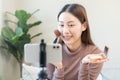 Beauty blogger, asian young woman, girl vlogger makeup face, showing, reviews cosmetics products while recording video, tutorial