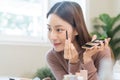 Beauty blogger concept, beautiful and cute asian young woman, girl makeup face by applying brush for eyes on eyebrow, eyeshadow Royalty Free Stock Photo