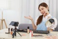 Beauty blogger concept, Young Asian woman recommend how to using cosmetics in live streaming