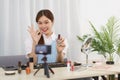 Beauty blogger concept, Young Asian woman recommend nail polish to subscribers in live streaming