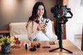 Beauty blogger copycat female filming daily make-up routine tutorial on camera. Influencer young woman live streaming