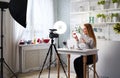 Beauty blogger woman filming make-up asks for likes, thumbs up, subscription on camera. Influencer blonde girl live Royalty Free Stock Photo