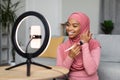 Beauty blogging. African american woman in hijab making makeup and recording video tutorial for her blog