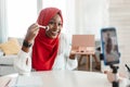 Beauty blogging. Black islamic influencer lady recording makeup review, applying blush and capturing video for her blog Royalty Free Stock Photo