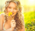 Beauty blond model girl smelling dandelion Royalty Free Stock Photo