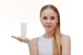 Beauty blonde holds a jar of shampoo or conditioner in her hands. Long blonde hair Royalty Free Stock Photo