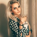 Beauty blonde lady with glass of martini looking at camera Royalty Free Stock Photo